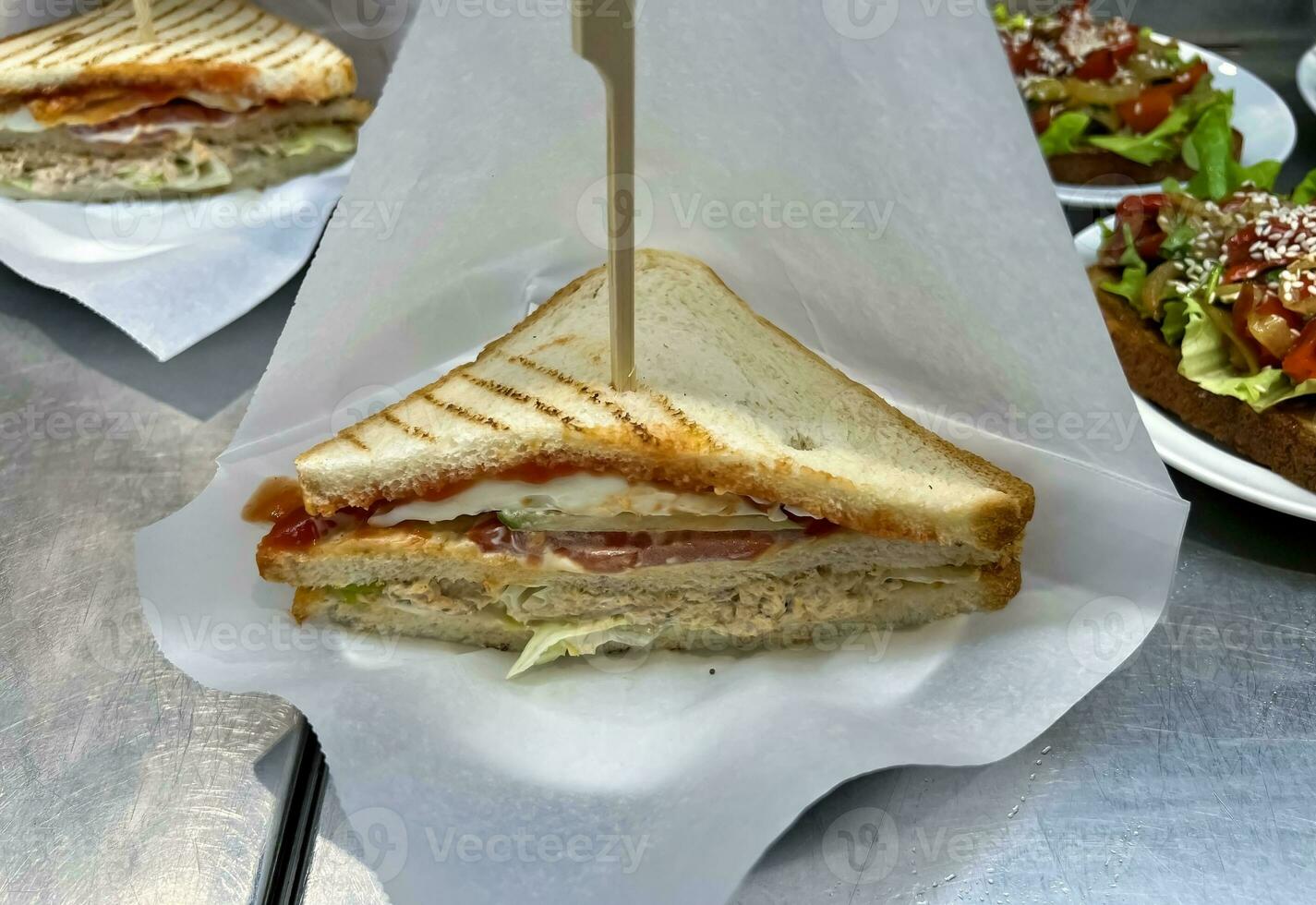 Triangular sandwich with chicken, vegetables and sauce photo