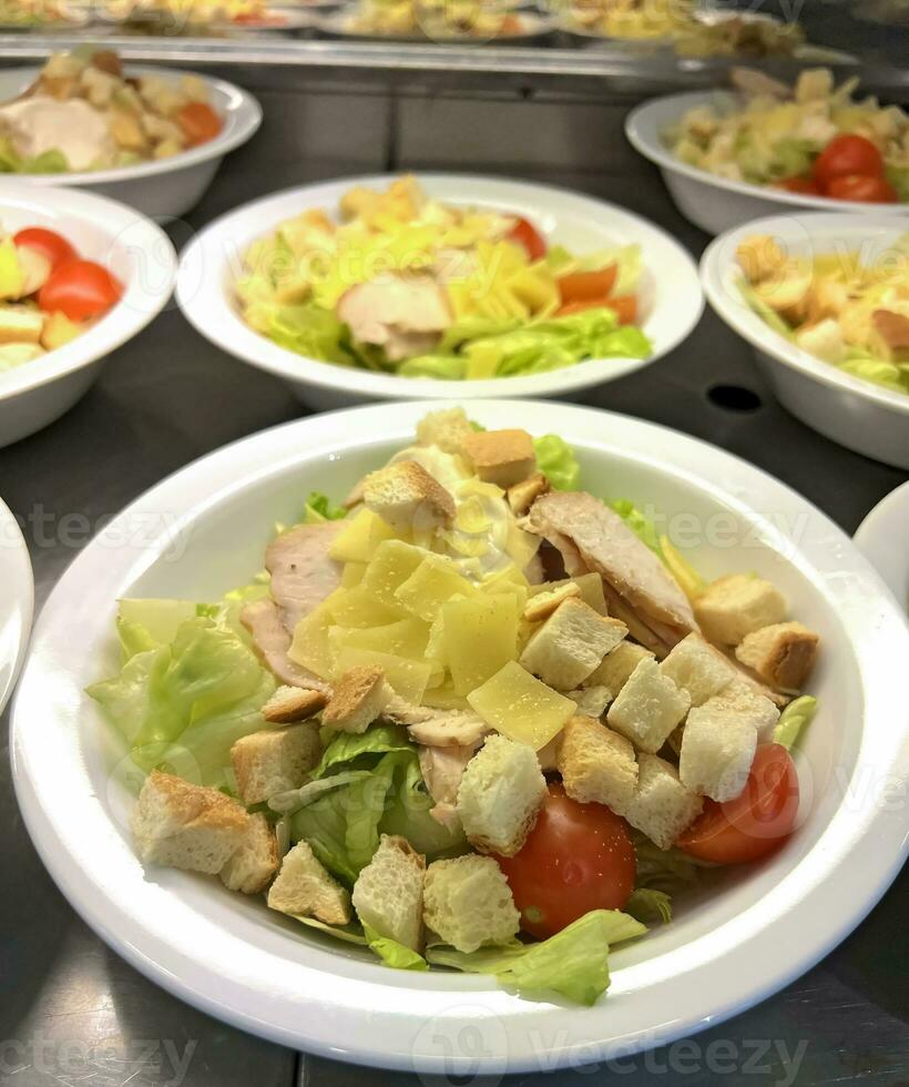 Caesar salad with chicken and crackers photo