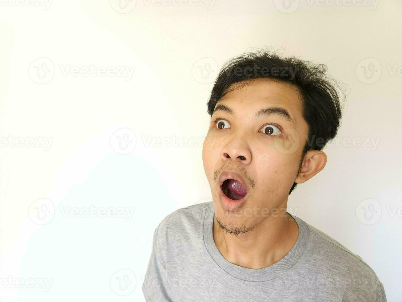 Asian man is whispering some secret gossip isolated on white background. photo
