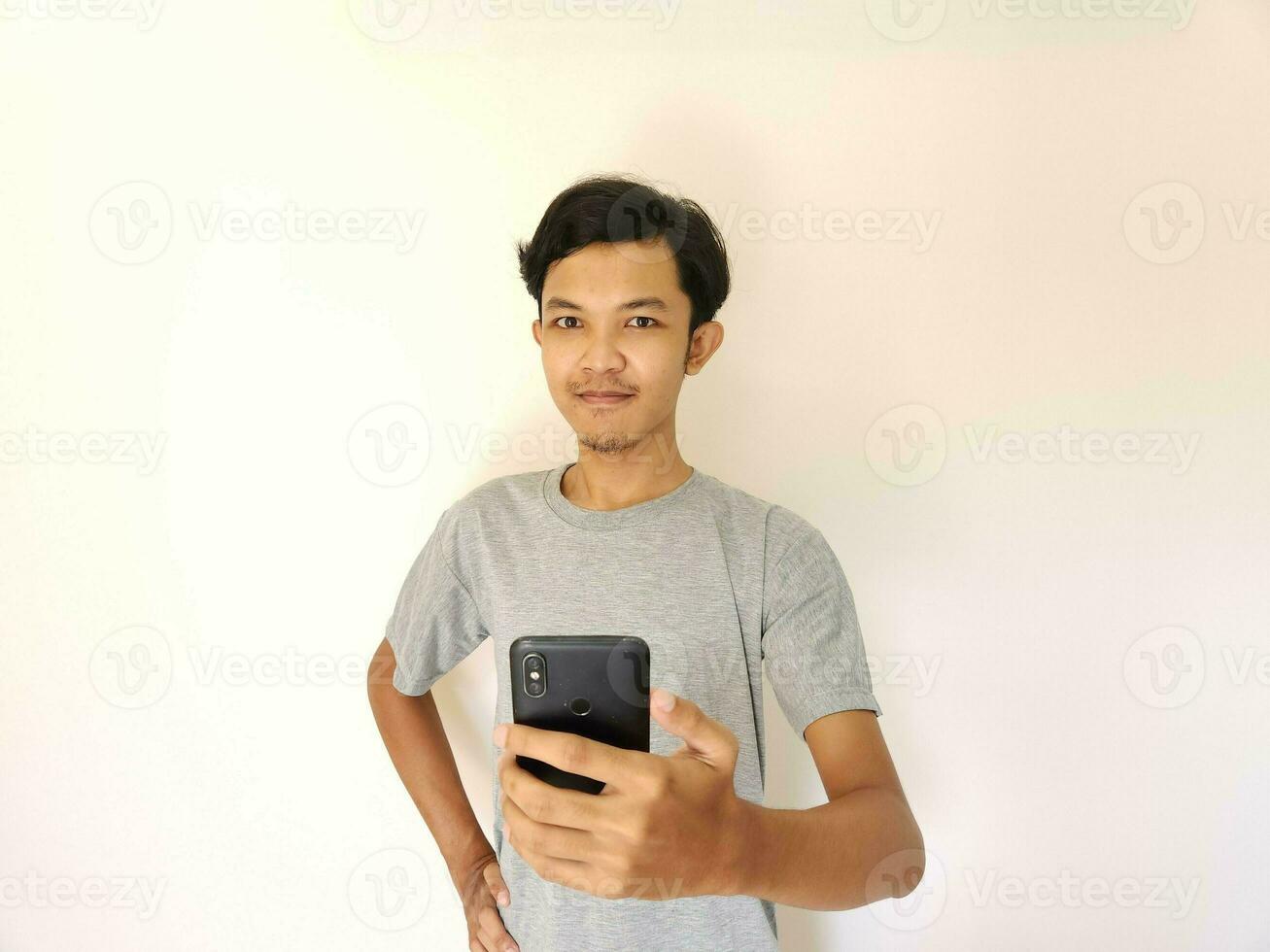 Wow and surprise face asian man use smartphone with copy space of advertisement photo