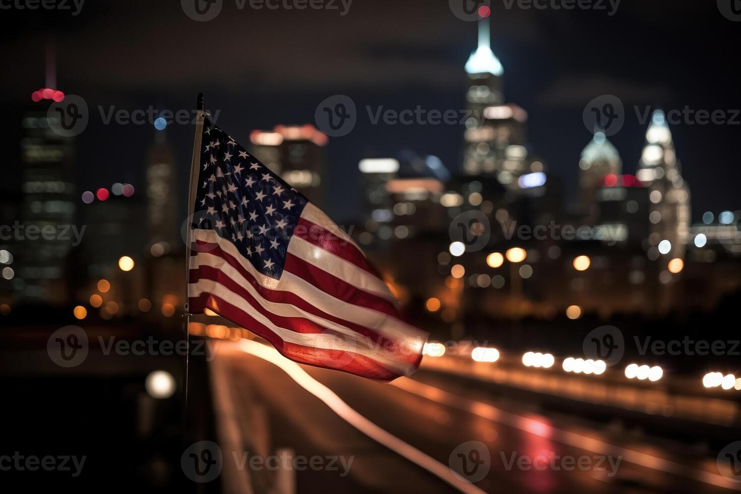 Photo of american flag in front of bokeh effect of cityscape in background.