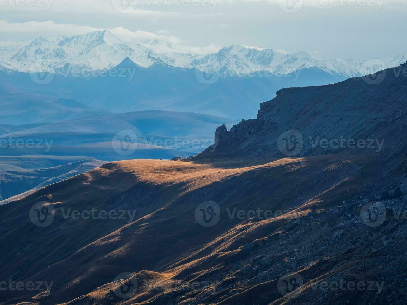 Soft focus. Mountains in a dense fog and sunny slope. Mystical l photo