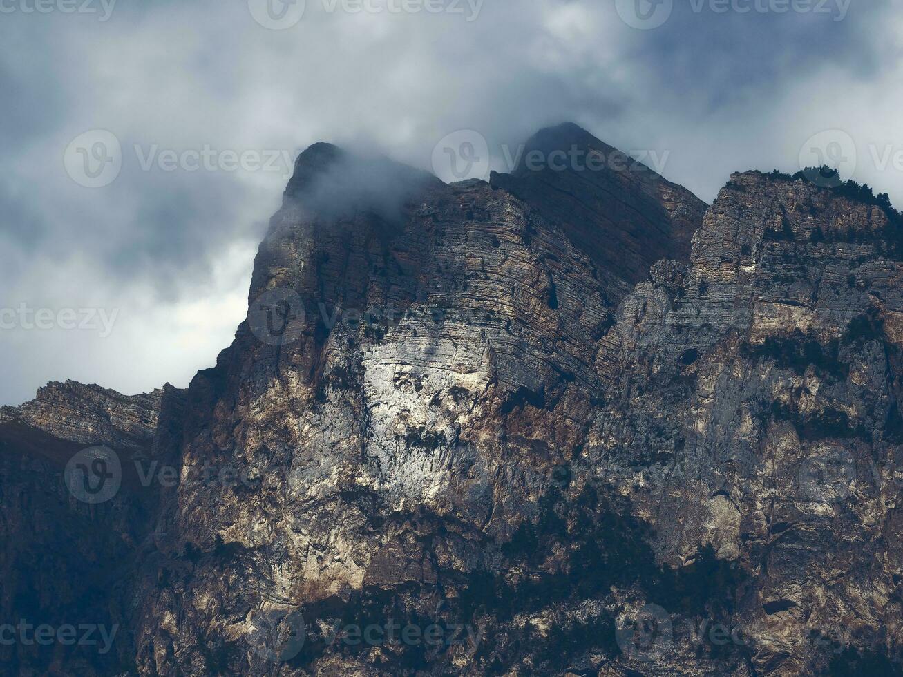 Night impressive silhouette of a skull on a high stone cliff, a mystical natural place in the Caucasus Mountains. Mountain spirit manifested in stone. photo