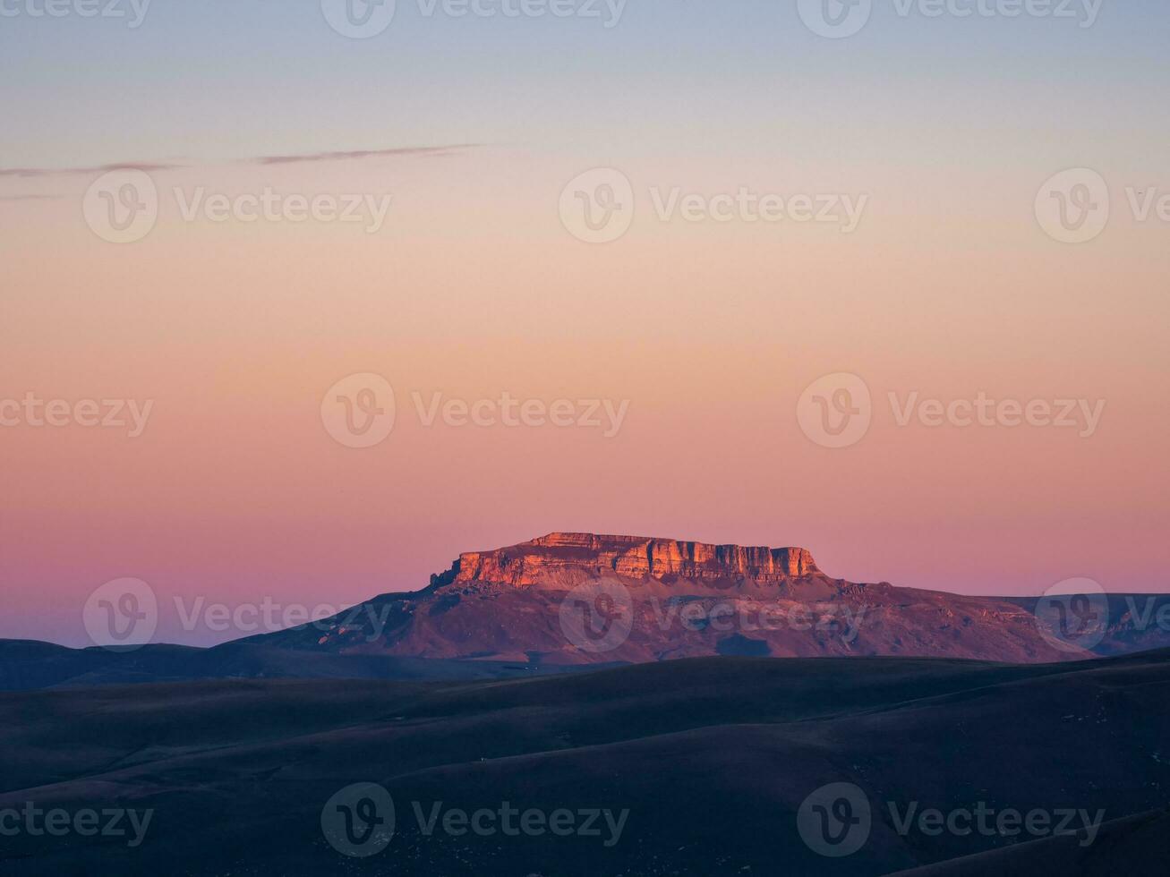 Magical magenta dawn over the Bermamyt plateau. Atmospheric dawn landscape with beautiful Bermamyt plateau is in the distance. photo