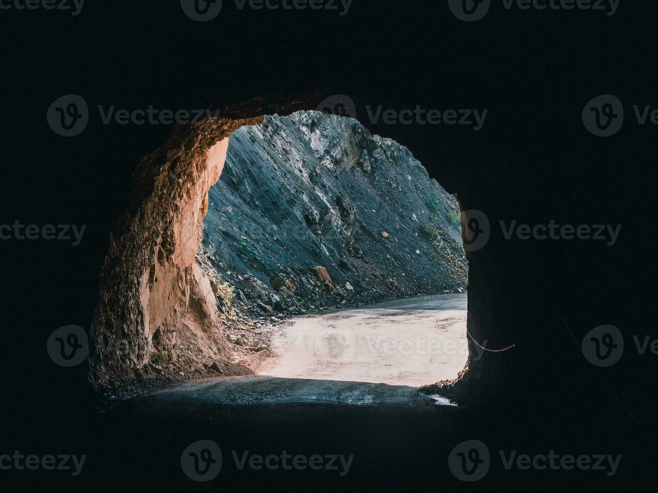 Exit from the dark mountain tunnel. photo