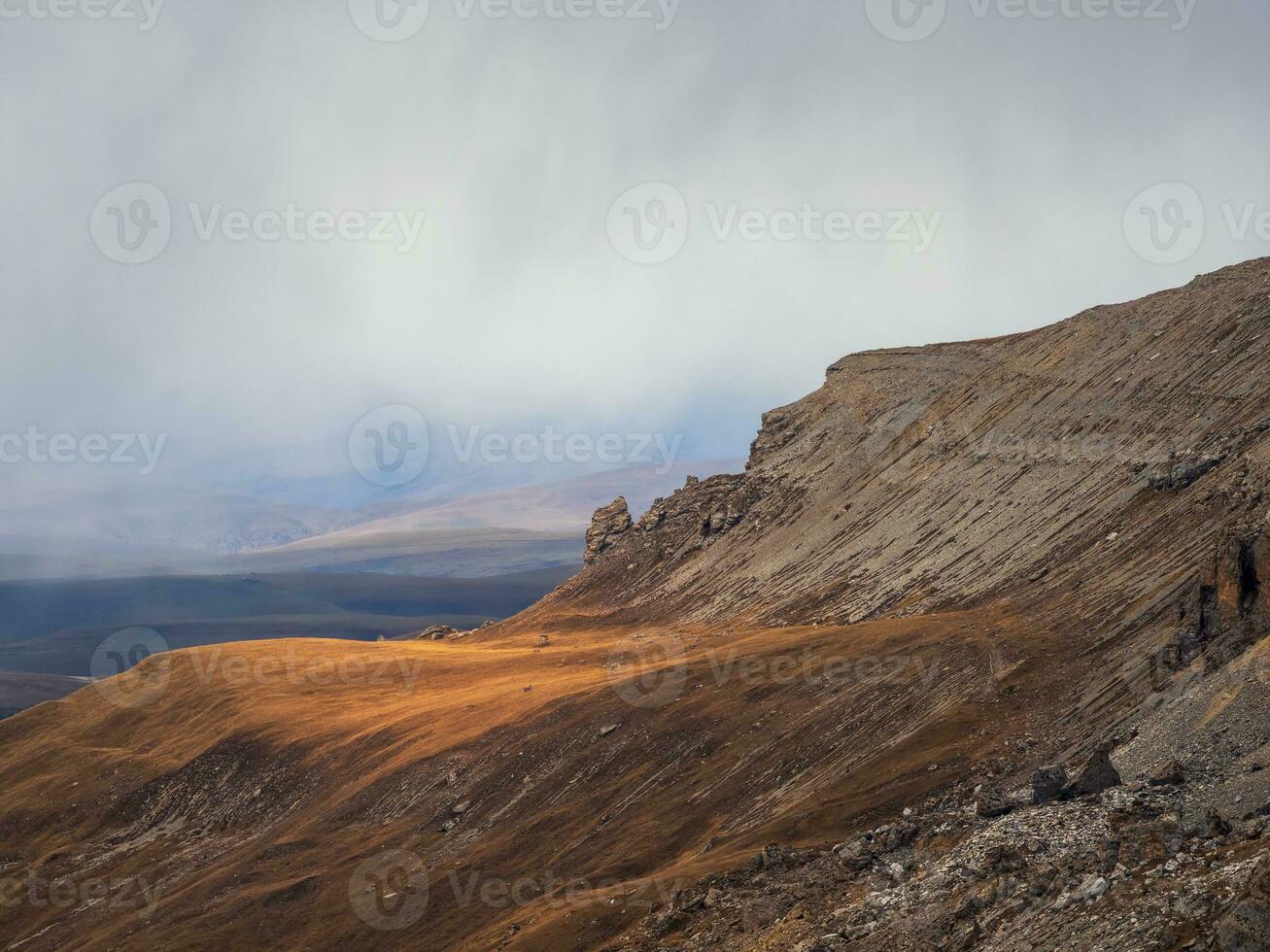 Soft focus. Foggy mountain view from cliff at very high altitude. Scenic alpine landscape with beautiful sharp rocks in sunrise. Beautiful scenery on abyss edge with sharp stones. photo