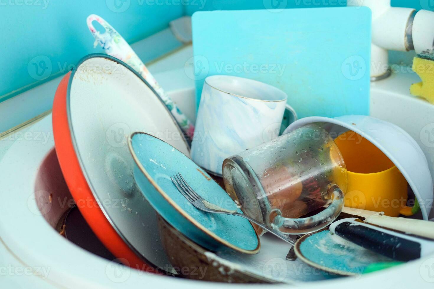 Sink with a pile of dirty dishes. Complete washing of crockery, tableware. Unsanitary conditions. photo