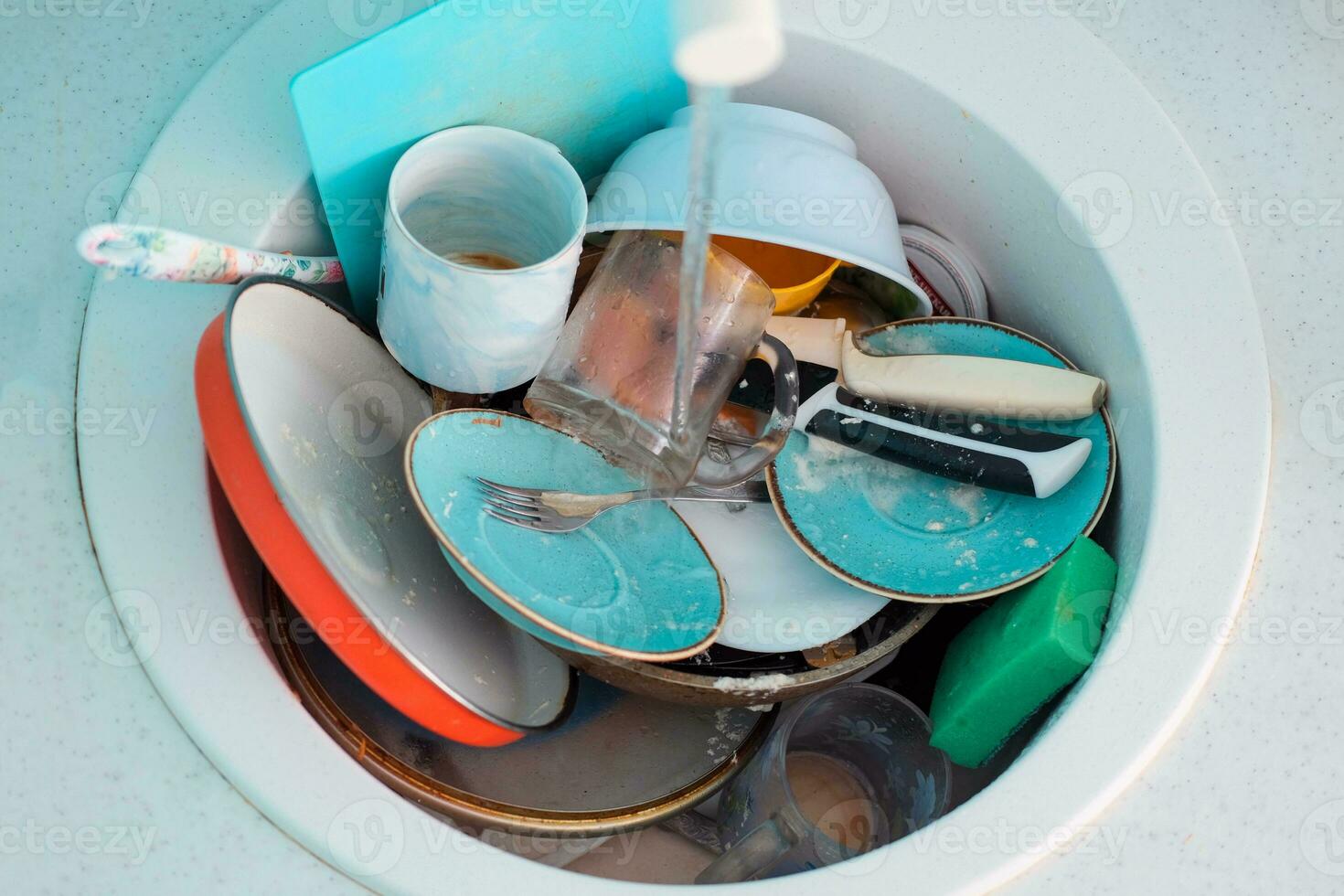 Sink with a pile of dirty dishes. Complete washing of crockery, tableware. Unsanitary conditions. photo