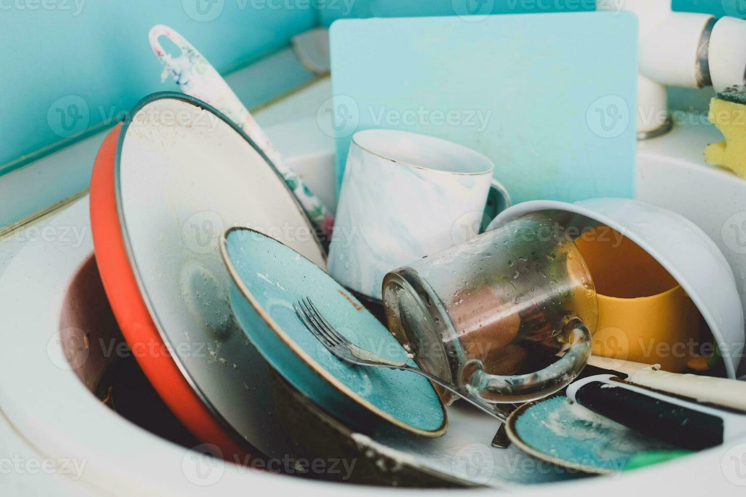 Sink with a pile of dirty dishes. Complete washing of crockery, tableware. Unsanitary conditions. photo
