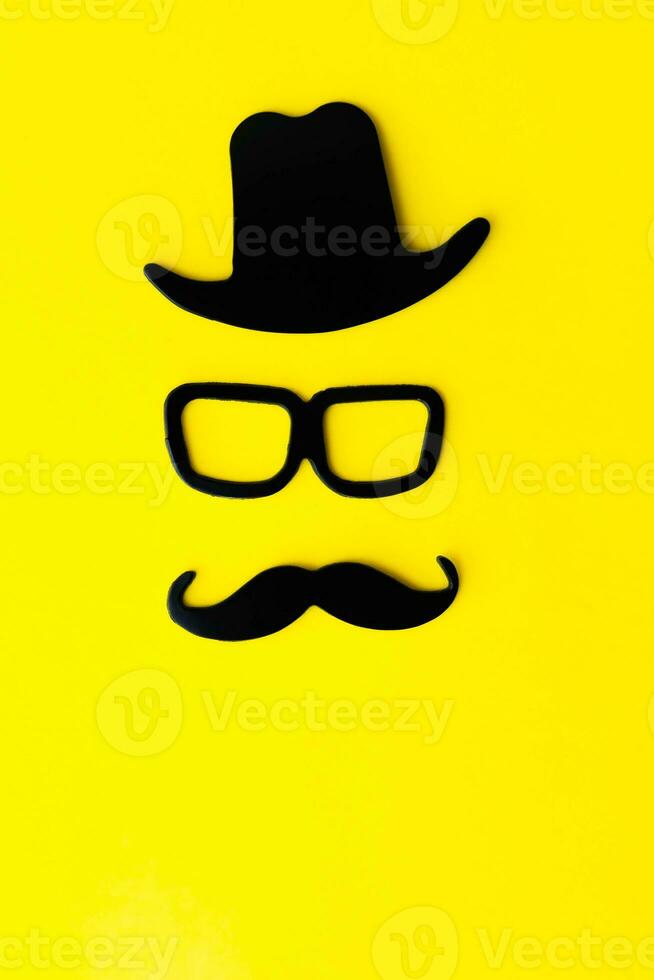 Happy fathers day sticker, hat, glasses, black mustache on a yellow background. Hipster objects. Father is day is a holiday. photo