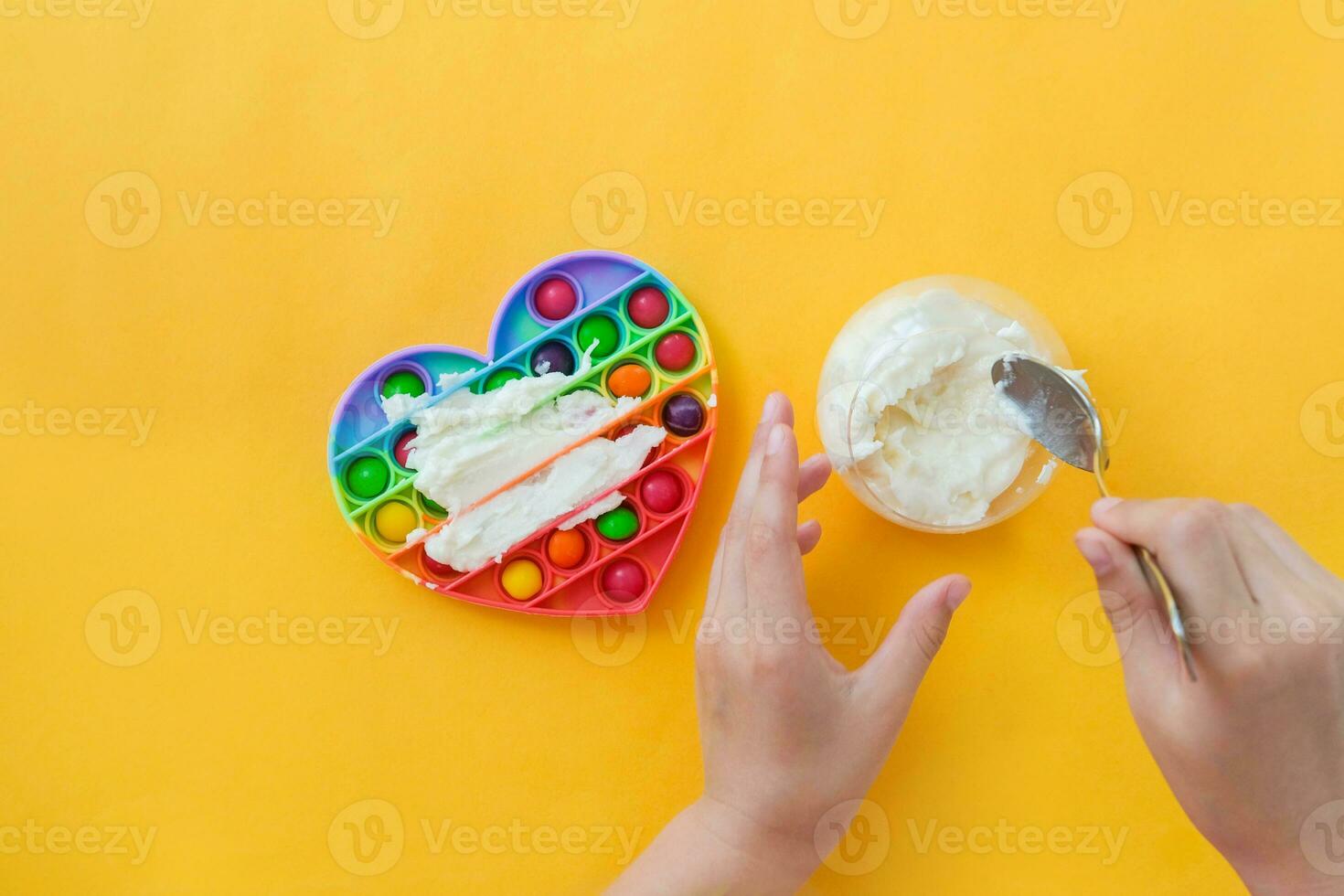 Use the popular pop it toy as a chocolate mold. White chocolate and colorful candies. DIY concept. Step-by-step photo instructions. Step 4.