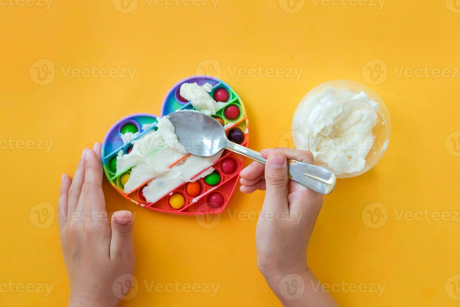 Use the popular pop it toy as a chocolate mold. White chocolate and colorful candies. DIY concept. Step-by-step photo instructions. Step 5.