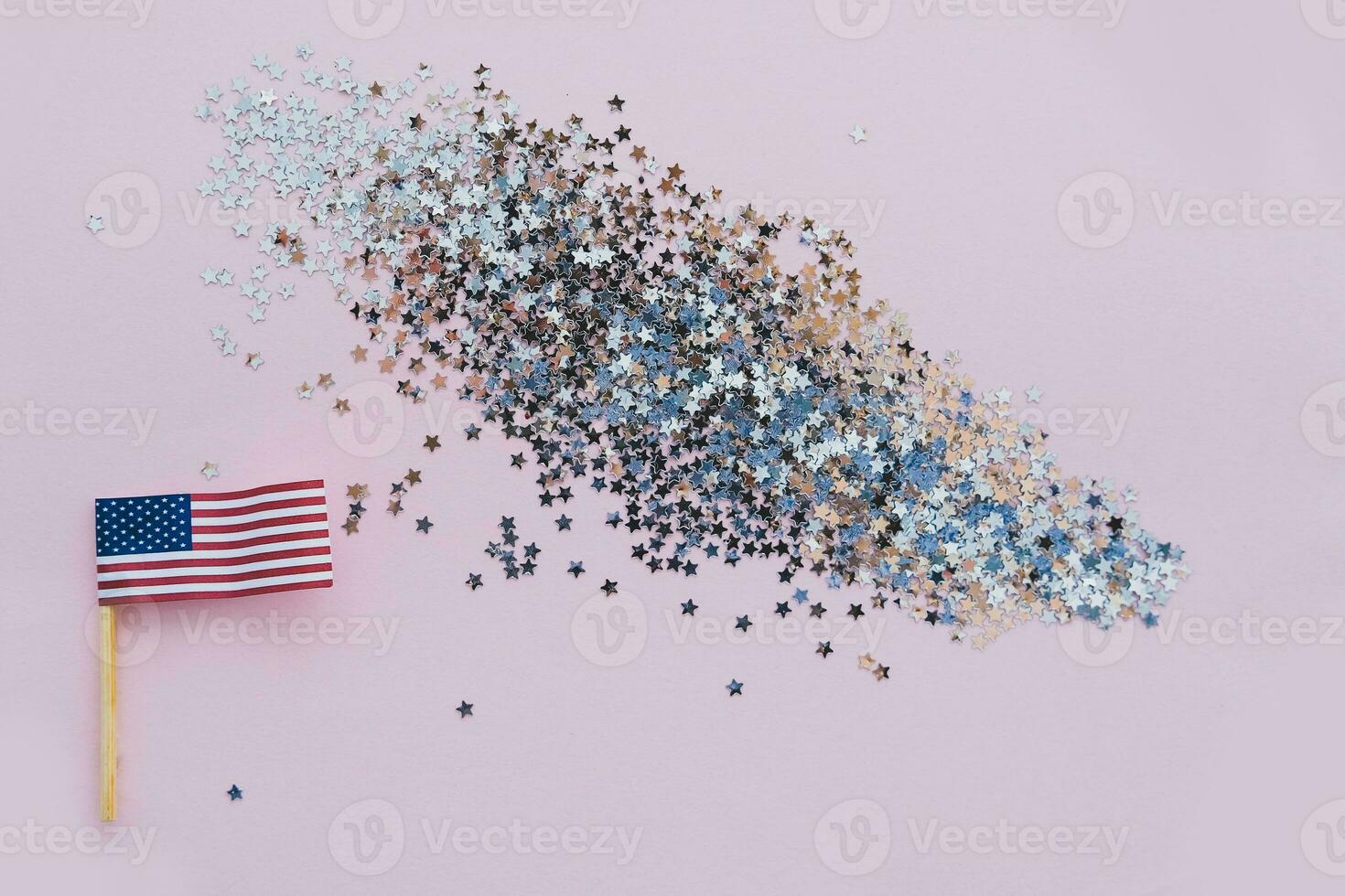 America flag and sparkles on pink background, flat lay. A holiday in America. 4th of July, America's Happy Independence Day. Labor day. Copy space for text. photo