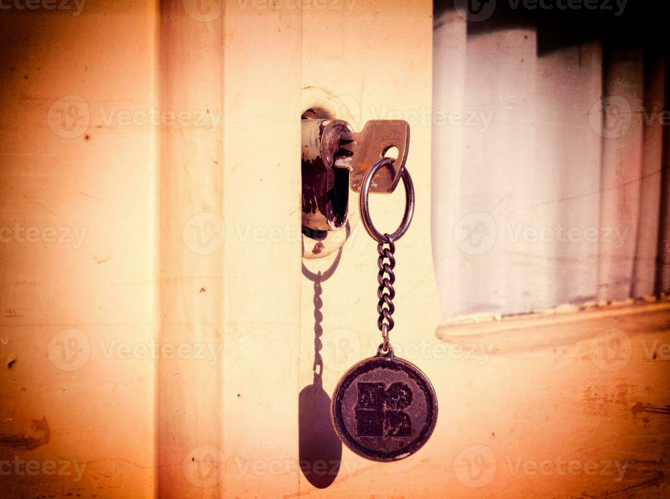 Old key in the door photo