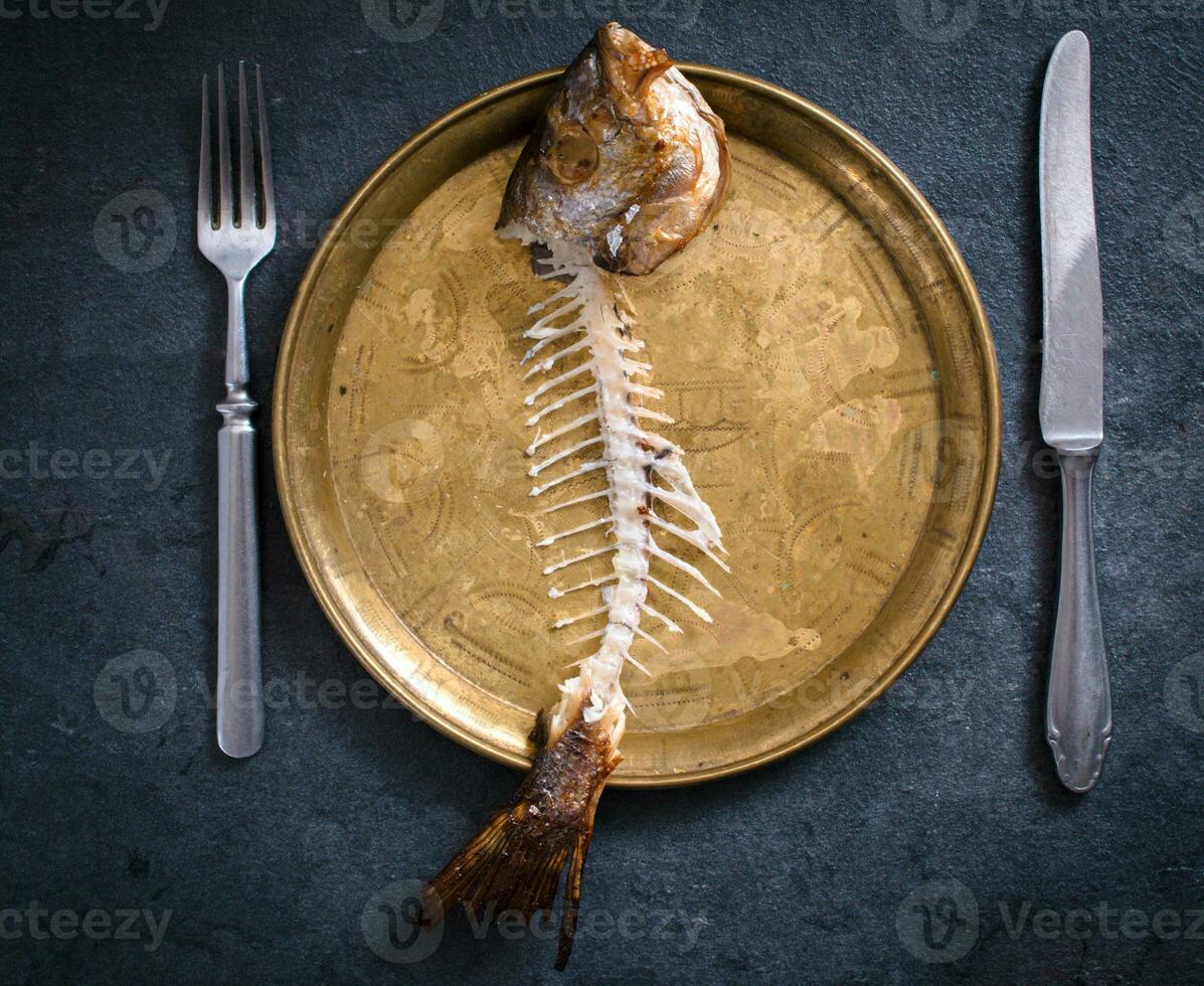 Fish skeleton in plate photo