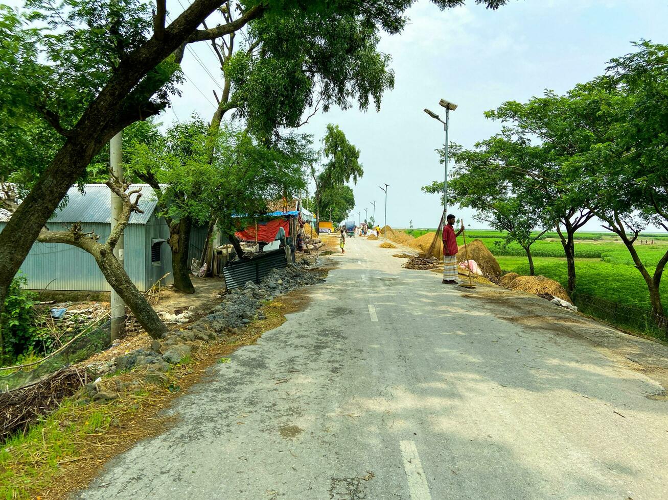 A road in the middle of a village field photo
