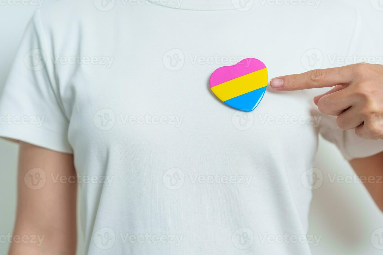 Pansexual Pride Day and LGBT pride month concept. hand holding pink, yellow and blue heart shape for Lesbian, Gay, Bisexual, Transgender, Queer and Pansexual community photo