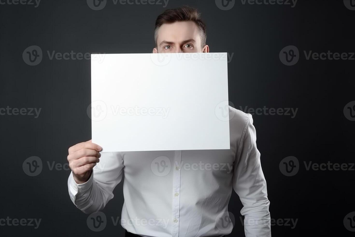 A man holds a blank white sign board mockup in his hand photo