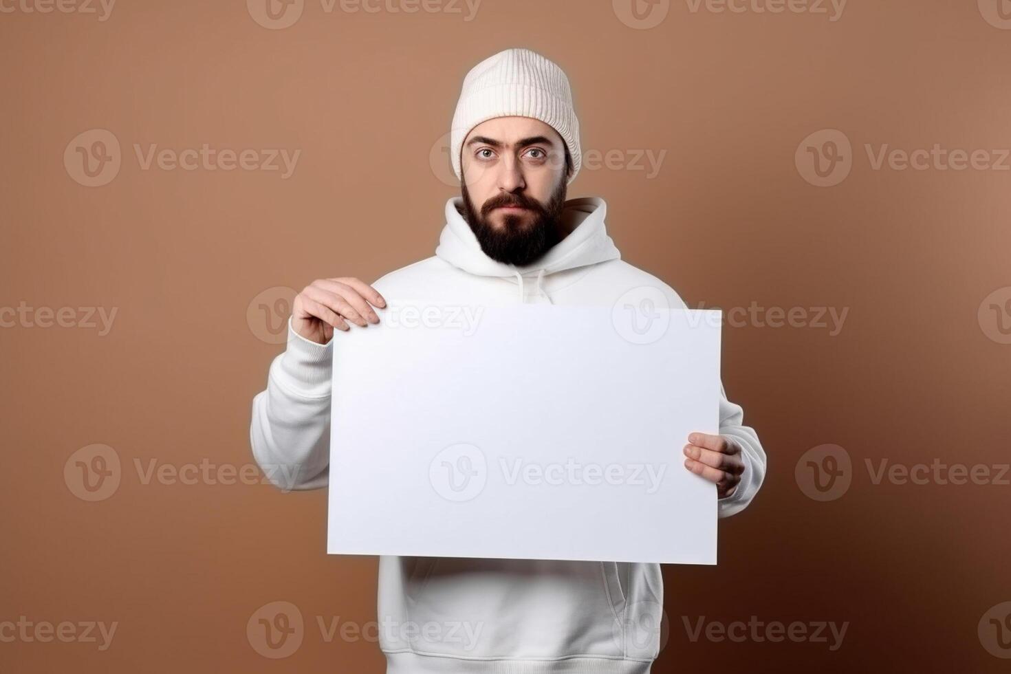 A man holds a blank white sign board mockup in his hand photo