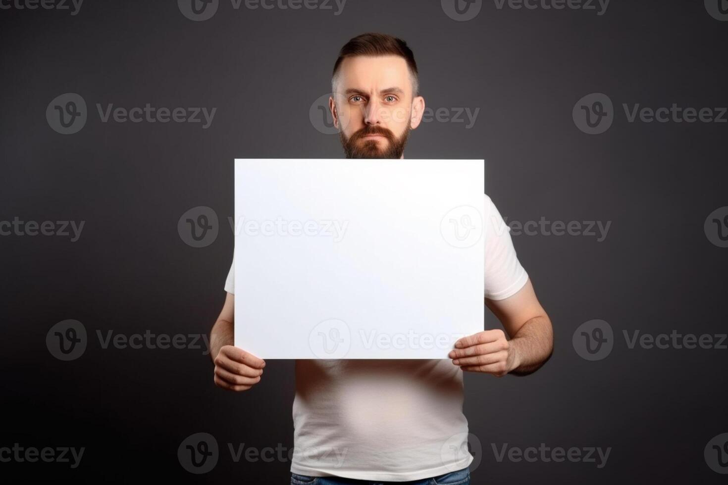 A man holds a blank white sign board mockup in his hand photo