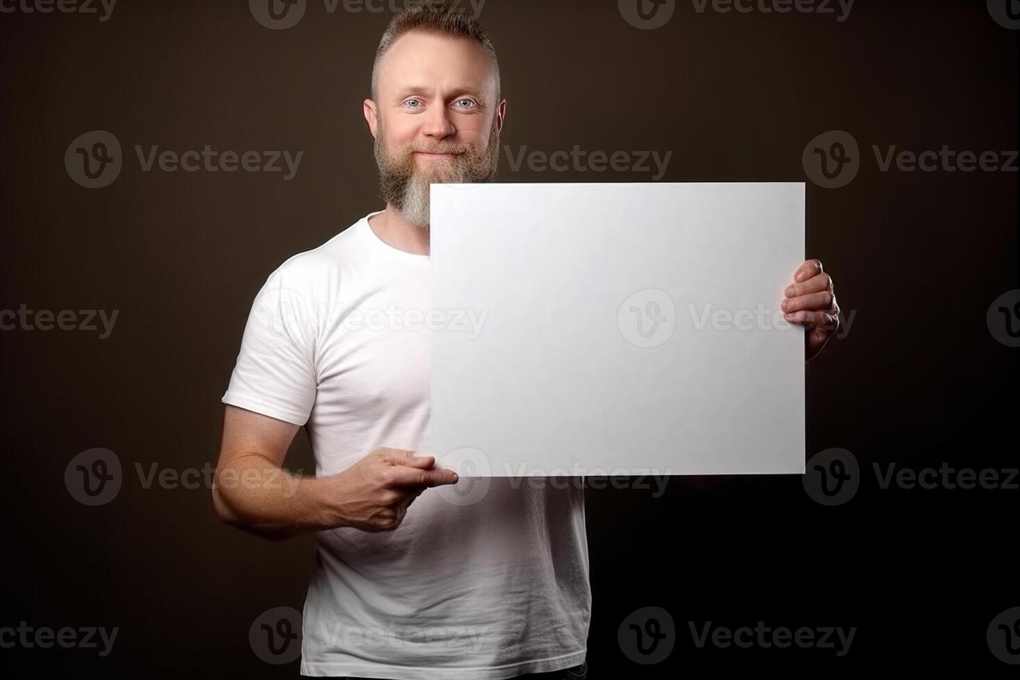 A man holds a blank white sign board mockup in his hand photo