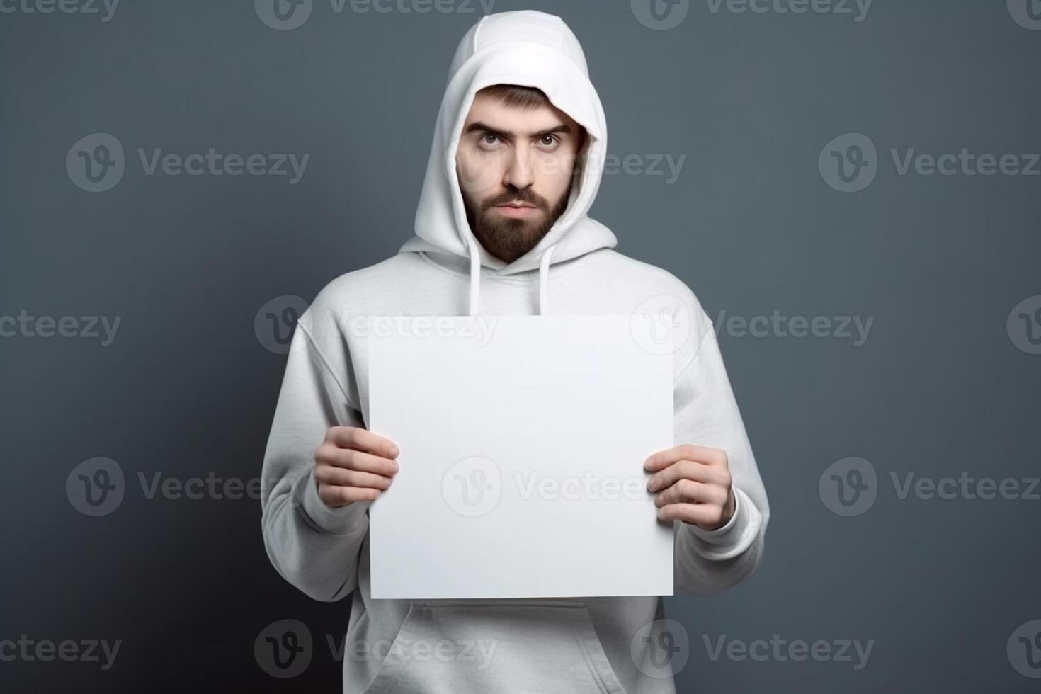 A man holds a blank white sign board mockup in his hand photo