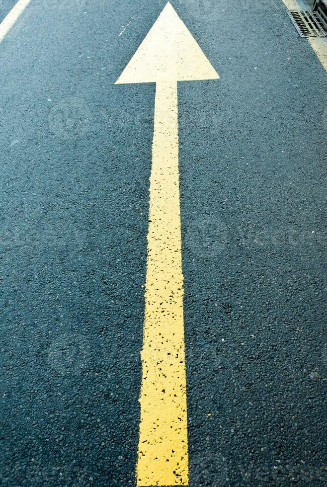 Yellow arrow sign photo