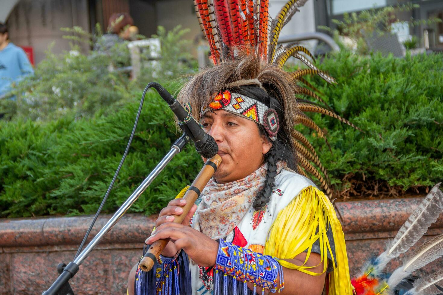 Grodno, Belarus - September 17 2016 Native American tribal group plays music and sings on the street for tourists and townspeople photo