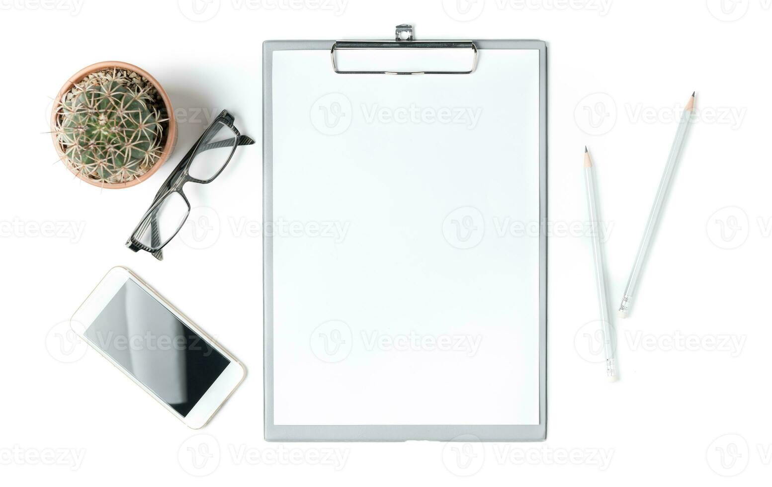 Modern white office desk table with blank paper, smartphone and glasses photo