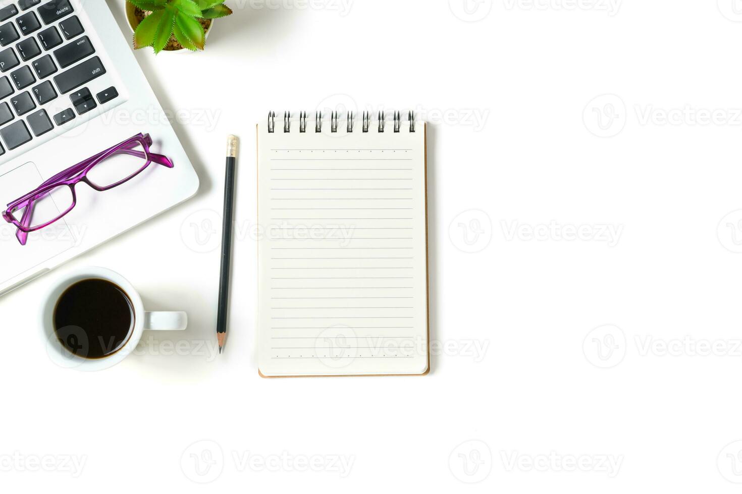 White office desk table with blank notebook, photo