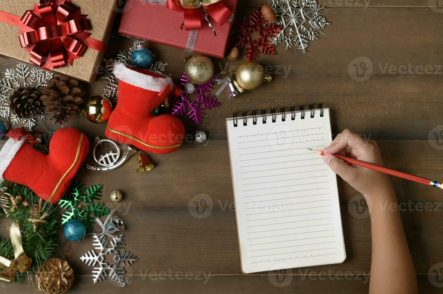 Little hand write on blank note paper with decorations and gift boxes photo