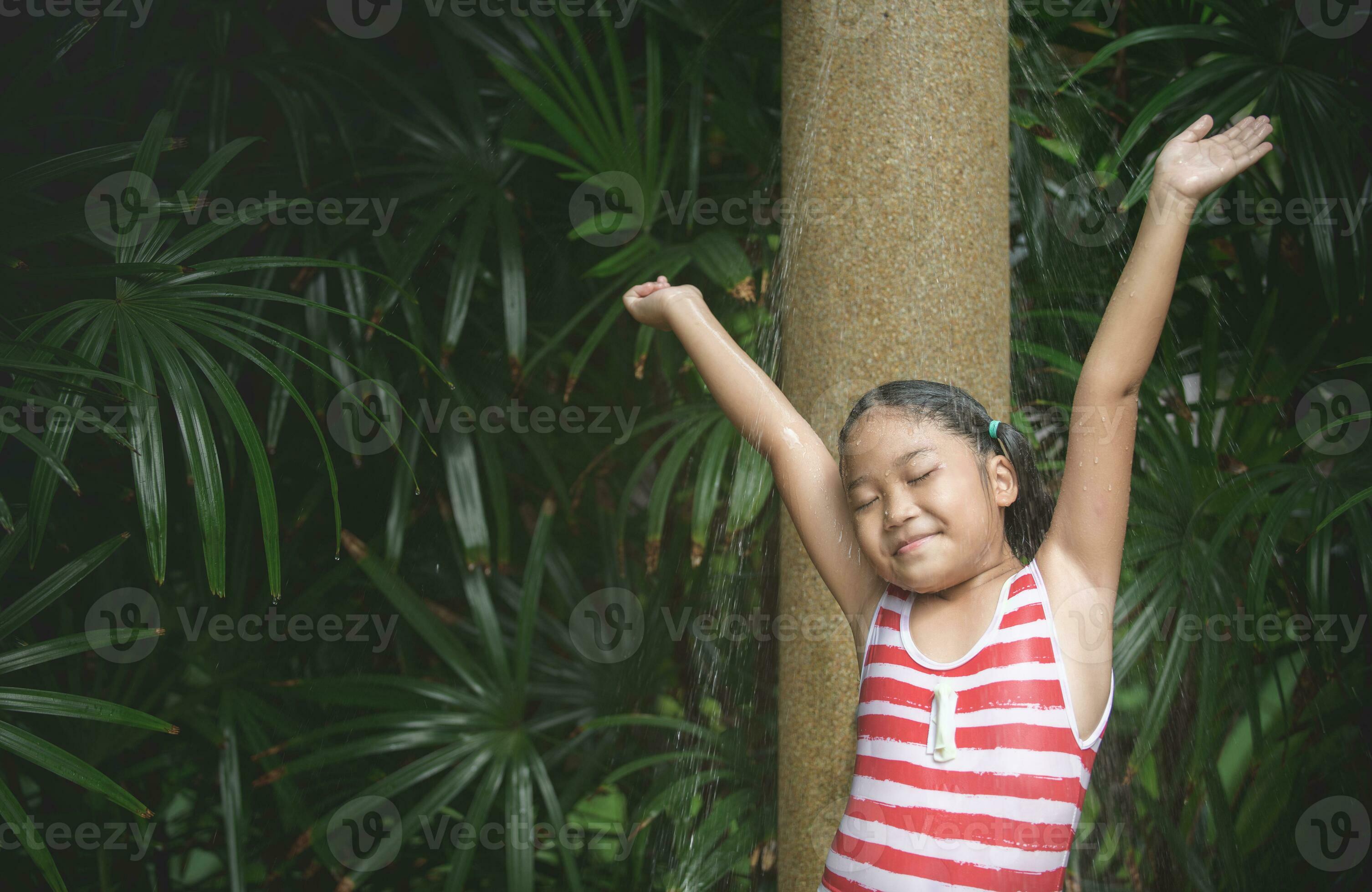 Happy cute girl taking shower before swimming, 23311274 Stock Photo at
