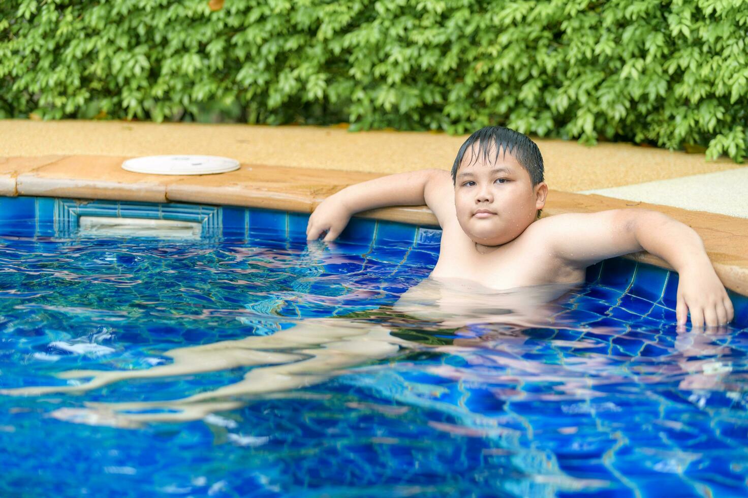 Obese boy relaxing enjoying hot tub bubble bath photo