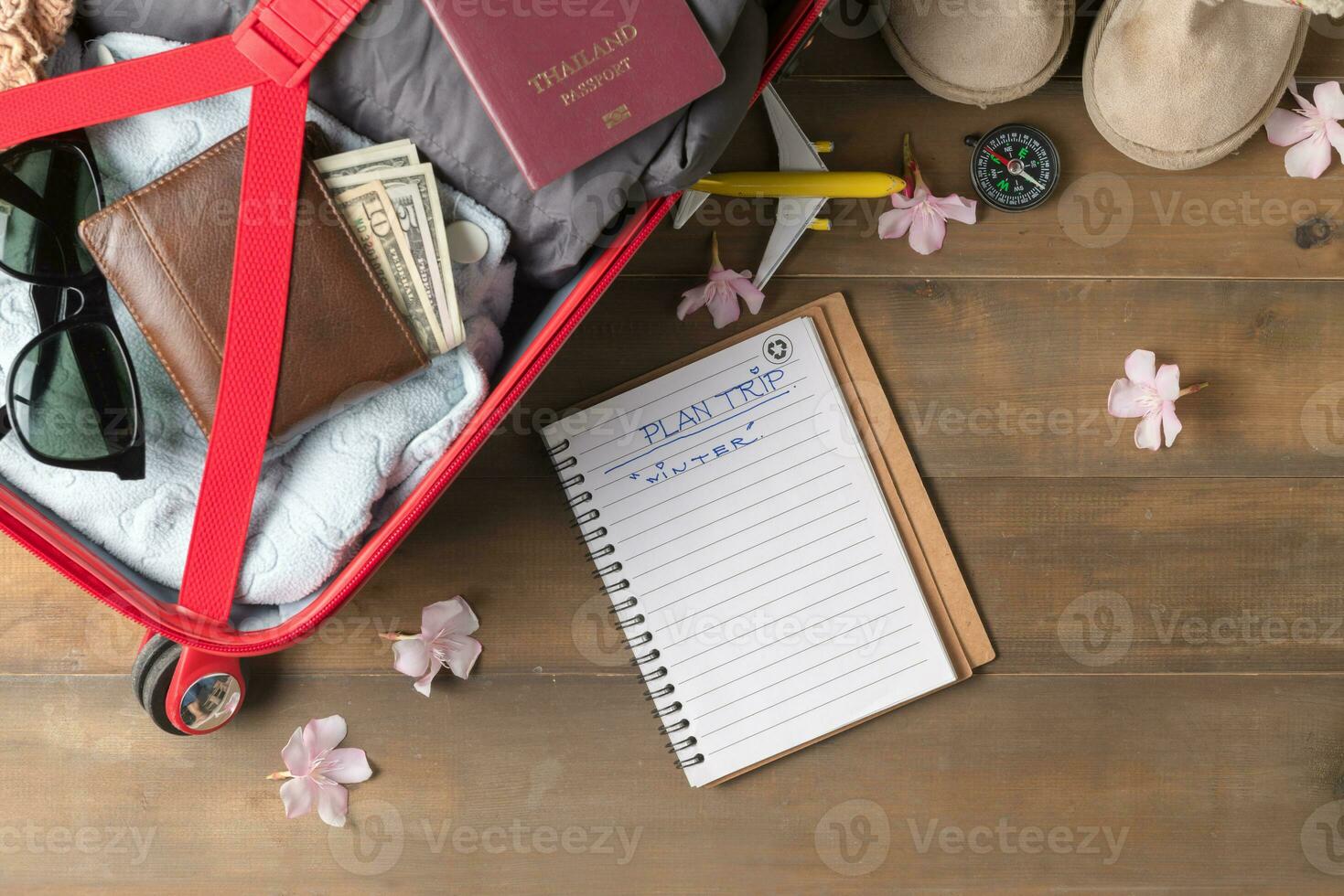 Plan trip on notebook and prepare accessories and travel items photo