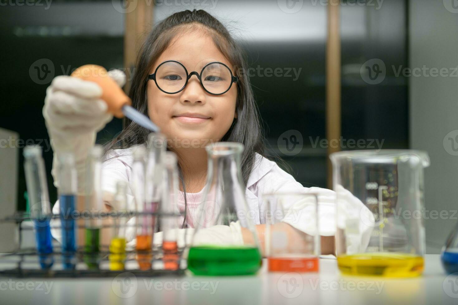 Little scientist use dropper to making experiment photo