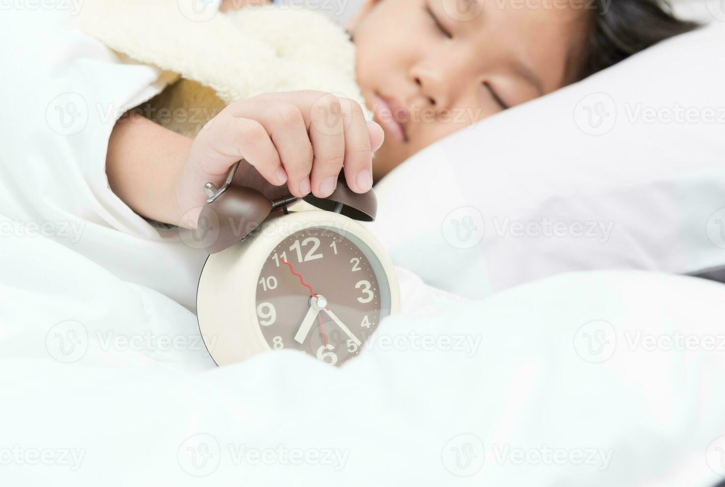 hand girl reaching to turn off alarm clock 23312501 Stock Photo at Vecteezy
