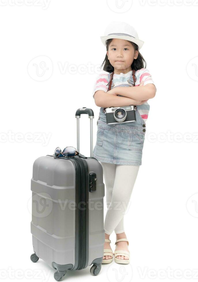 Happy traveler girl in hat and camera traveling with suitcase. photo