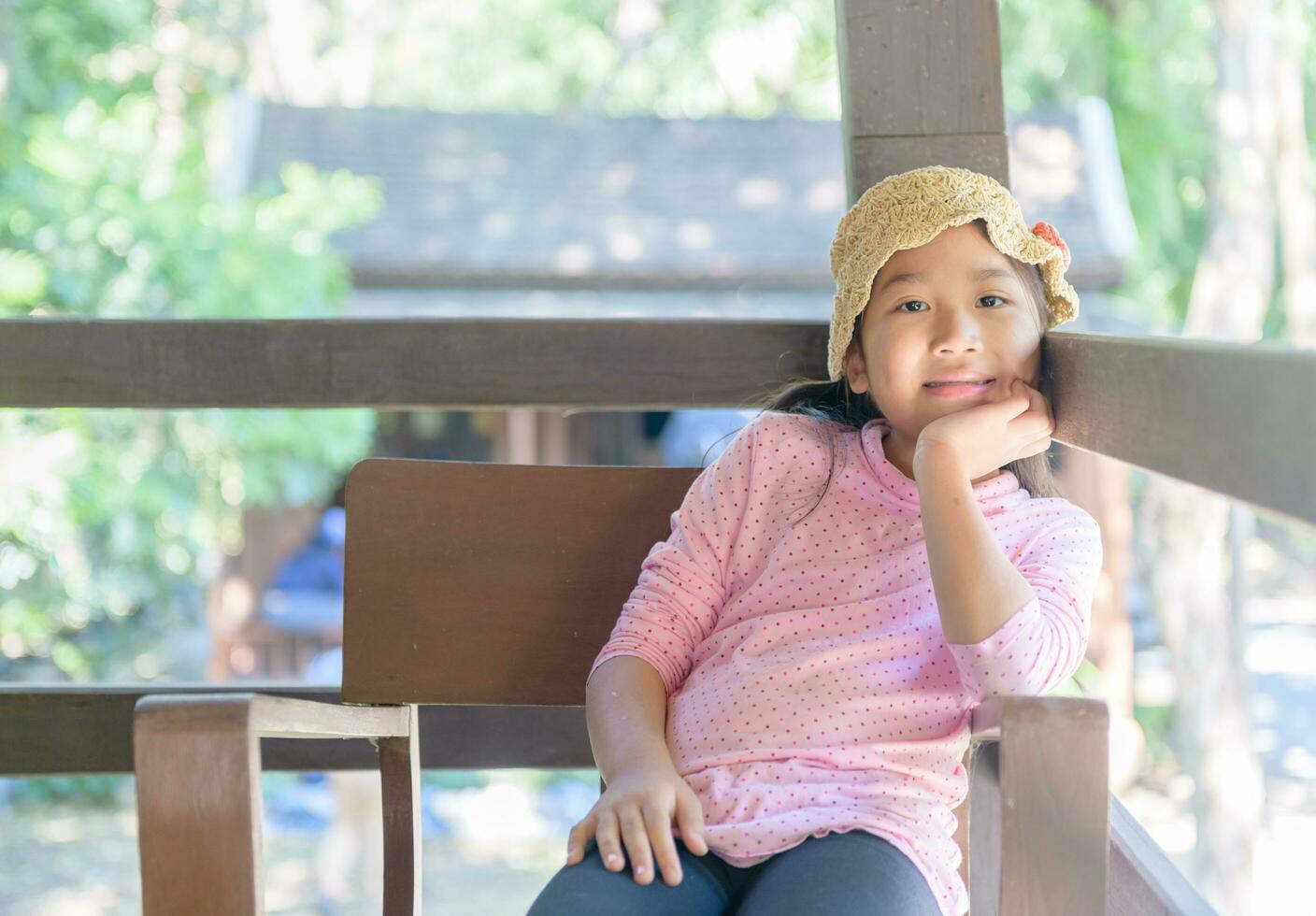 Cute asian girl smile and sitting on old chair, photo