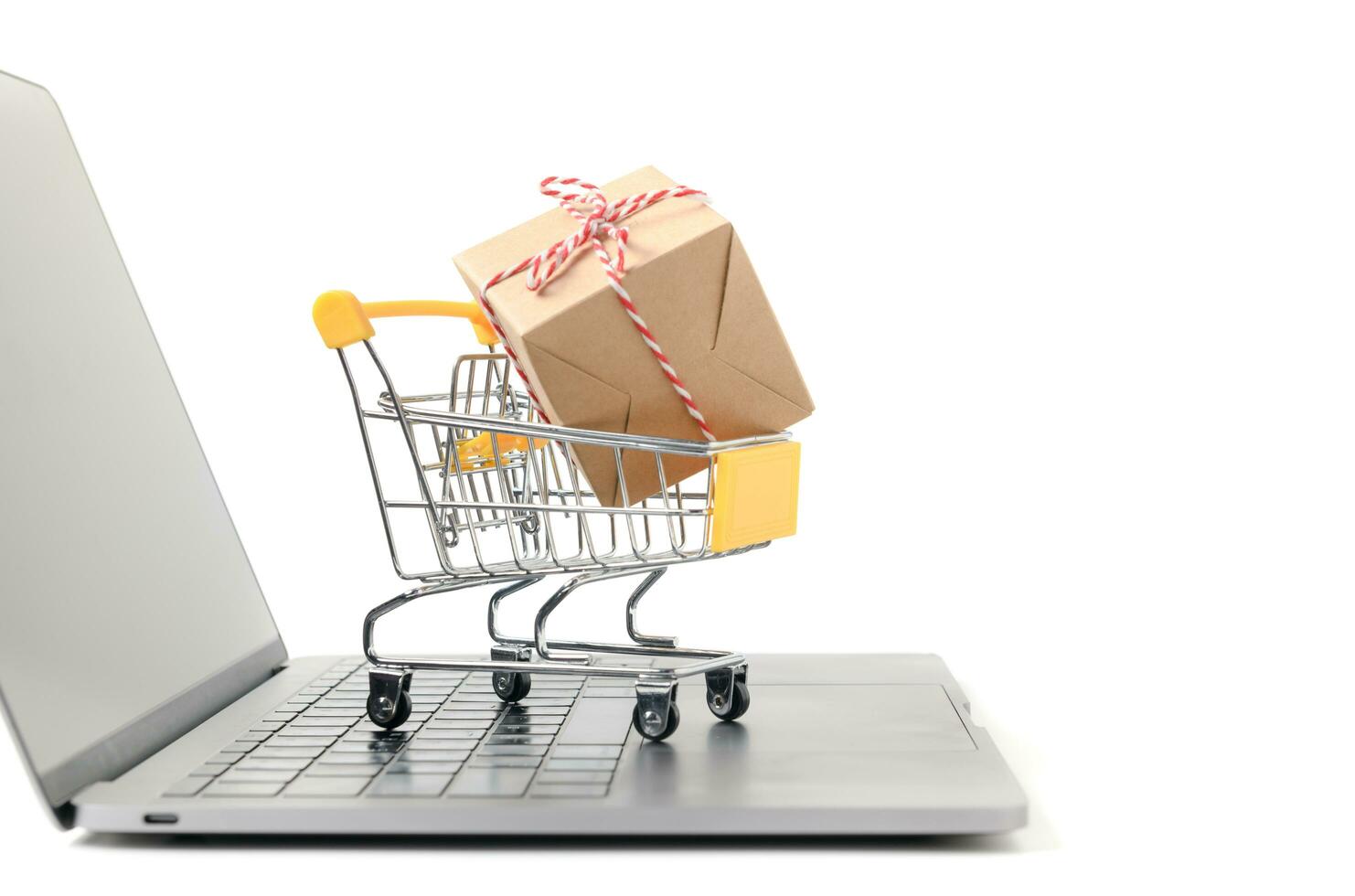 Boxes in a trolley on a laptop keyboard isolated photo