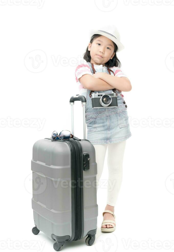 Happy traveler girl in hat and camera traveling with suitcase. photo