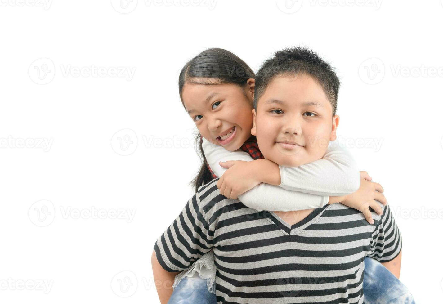 Brother giving piggyback ride to sister isolated on white photo
