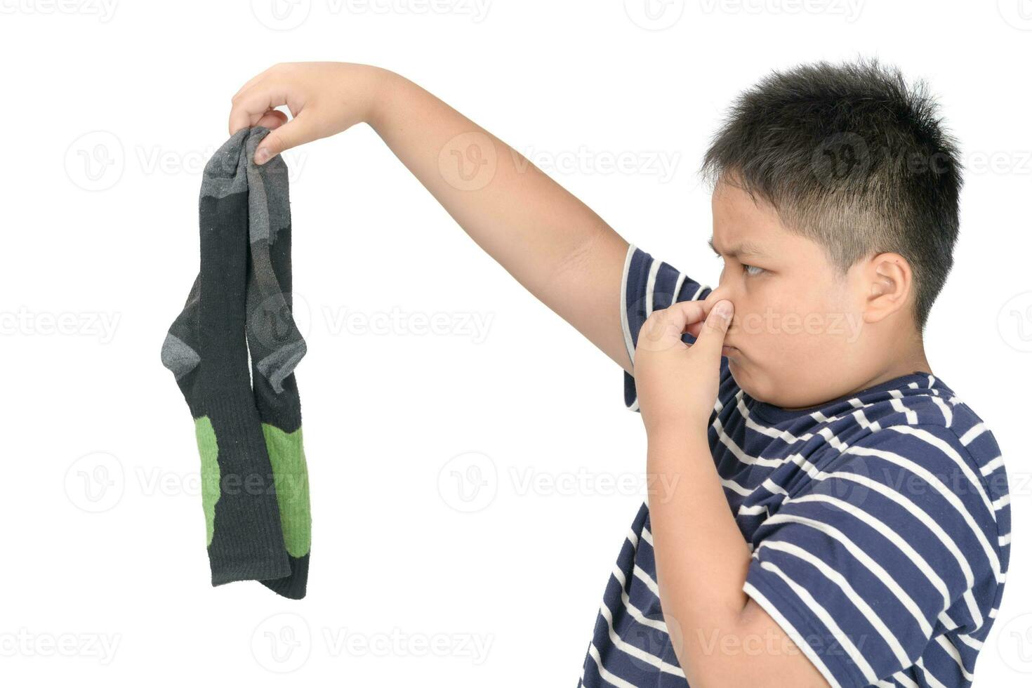 Fat boy holding dirty stinky football socks isolated photo