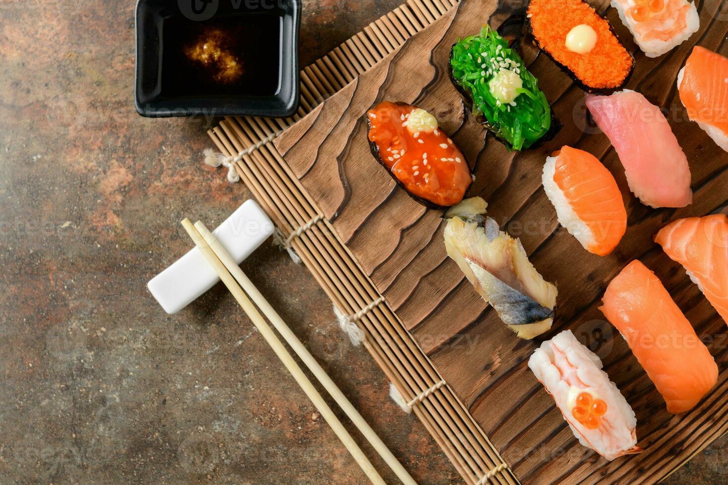 close up of sashimi sushi set with chopsticks photo