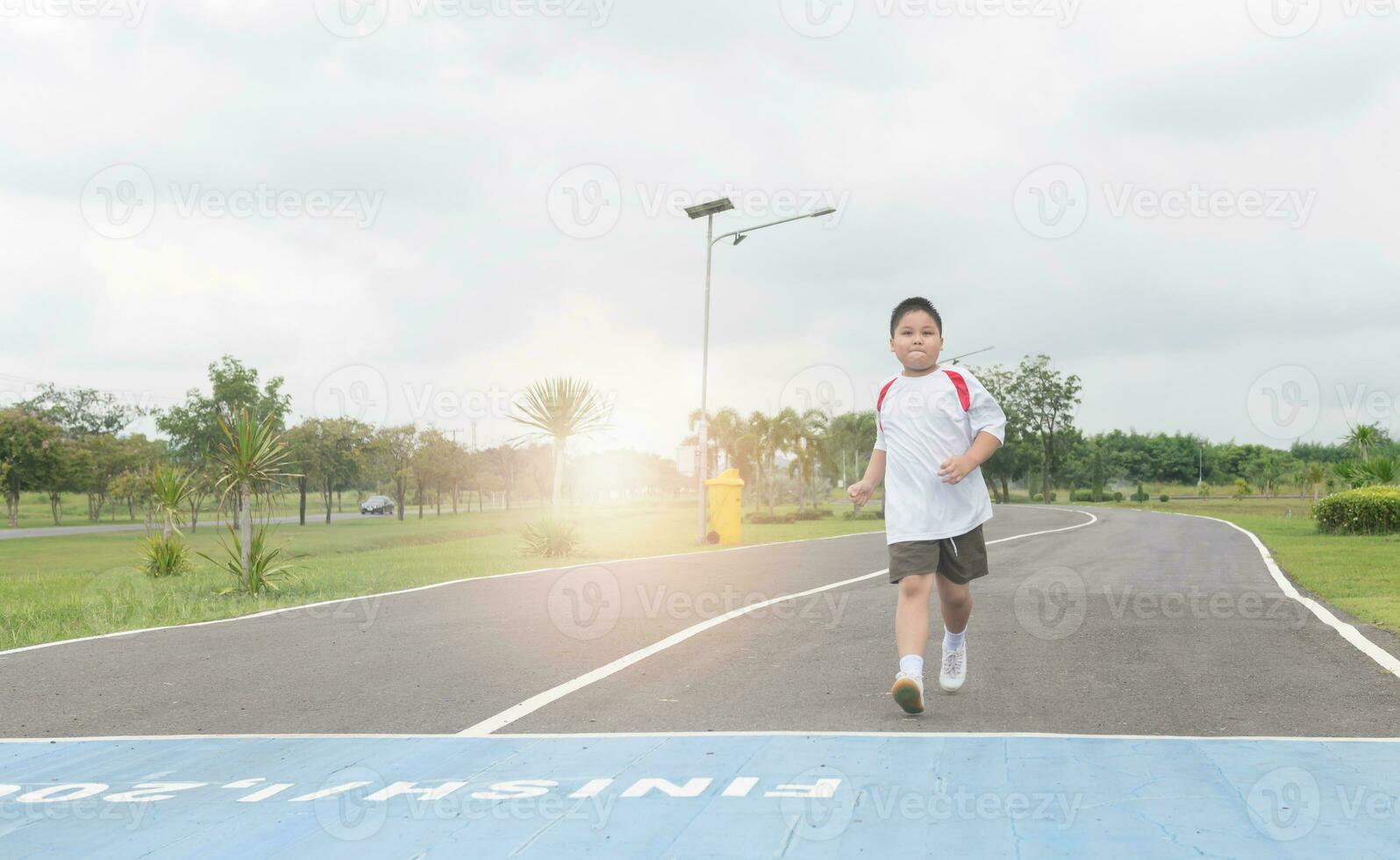 Obese fat boy running to the finished line. photo
