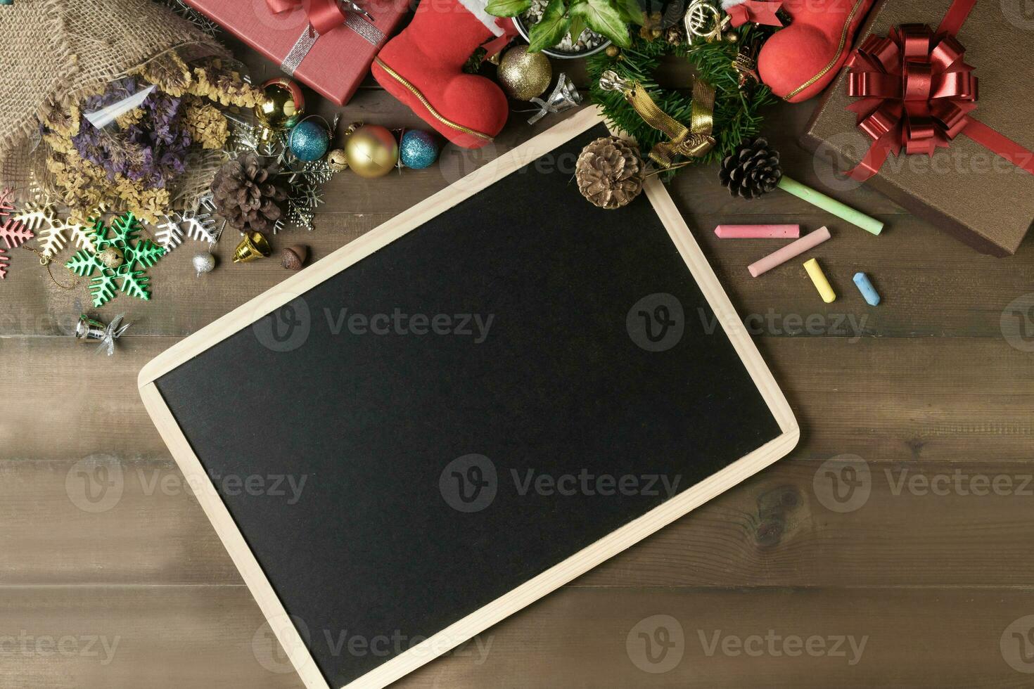 Blank black board with decorations and gift boxes, photo