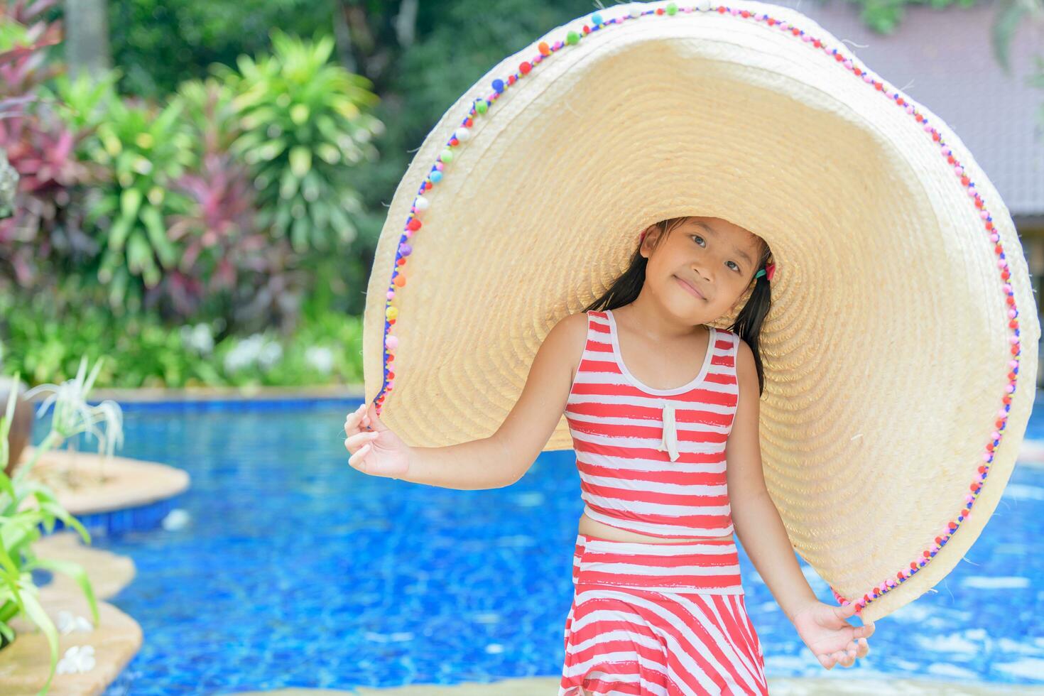 Cute girl in a swimsuit and a big hat photo