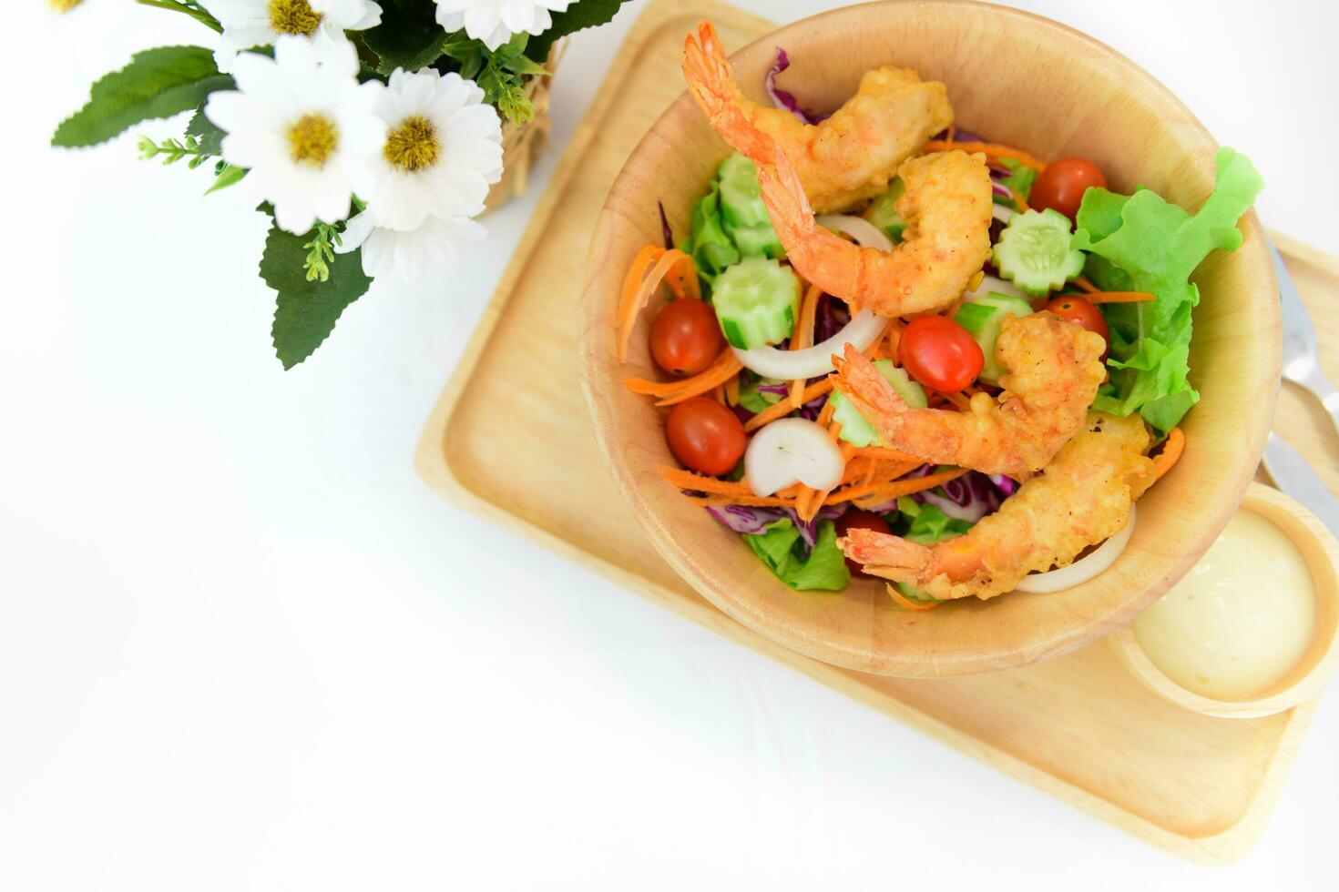 Fried shrimp salad on white table photo
