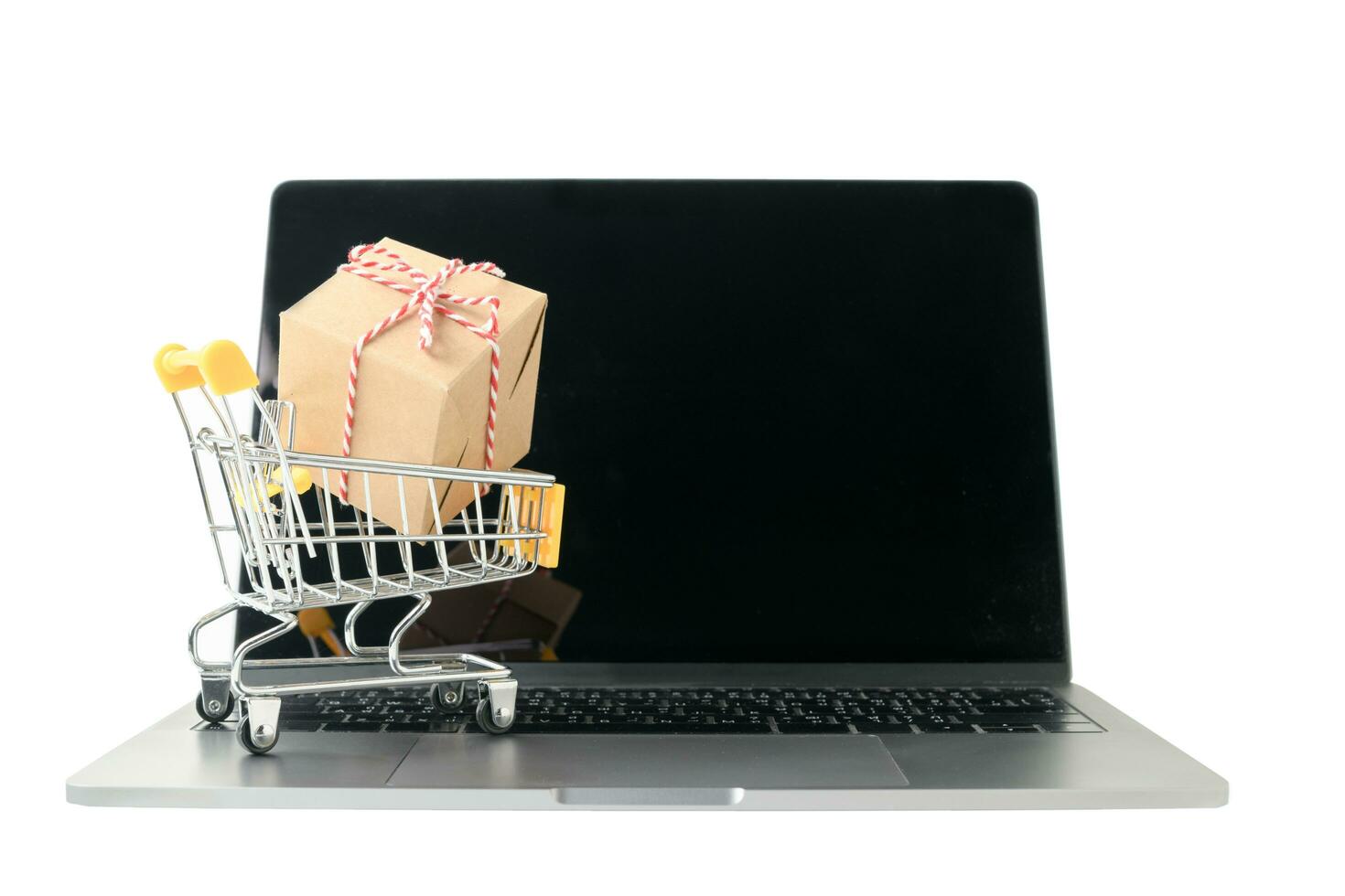 Boxes in a trolley on a laptop keyboard isolated photo