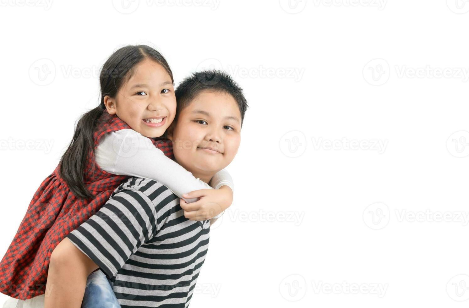 Brother giving piggyback ride to sister isolated on white photo