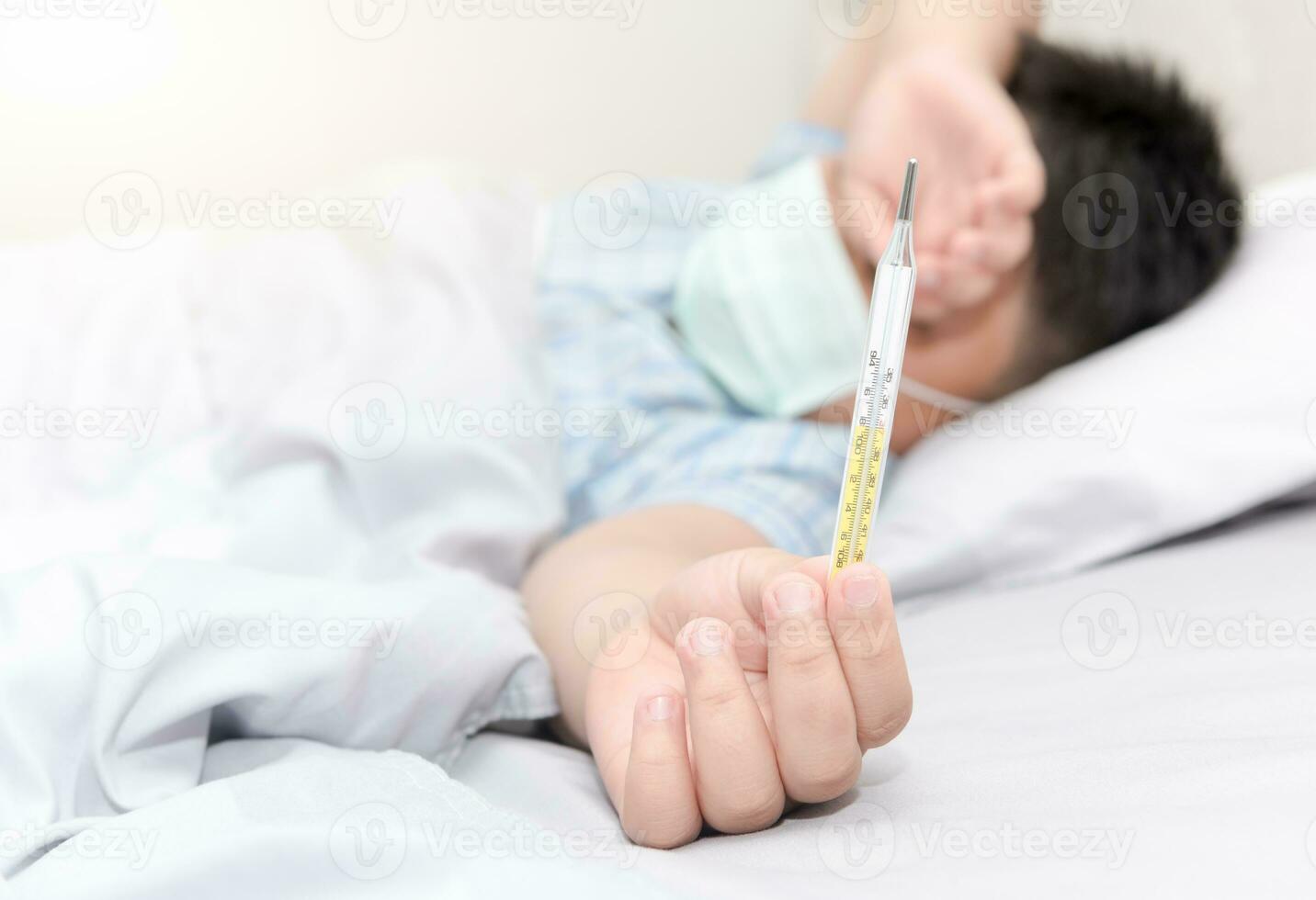 Thermometer in hand sick child photo